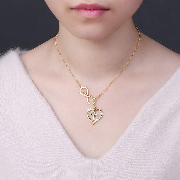 Woman wearing a Gold Infinity Heart Name Necklace with Custom Birthstone, featuring a heart and cross design, personalized with the name "Hayley" and sparkling birthstones.
