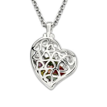A silver heart-shaped pendant with an intricate heart pattern design, showcasing colorful gemstones, hanging on a thick silver chain.