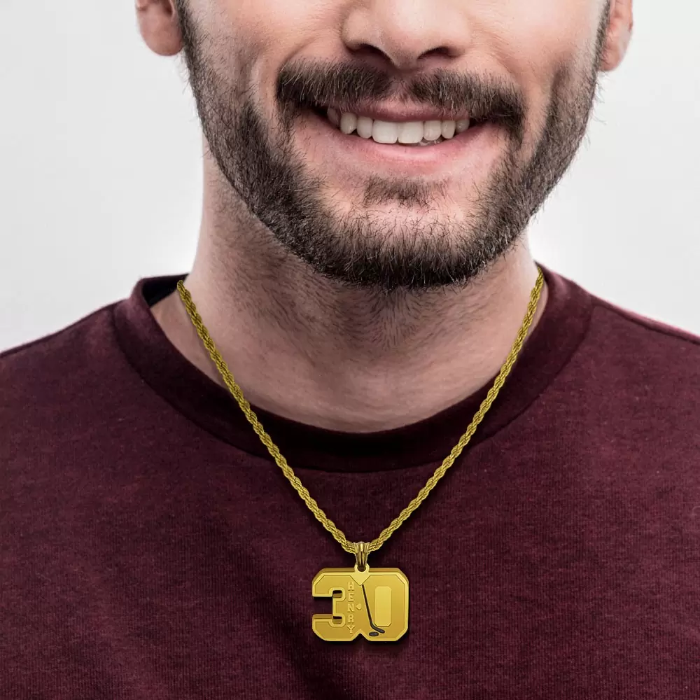 Smiling man with beard wearing a gold '30' hockey jersey pendant necklace.