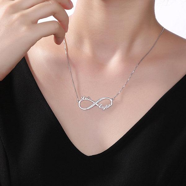 Woman wearing a Personalized Infinity Necklace in Sterling Silver 925 with Sparkling Diamonds, featuring the names "Lili" and "Taylor" on each loop.