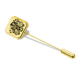 Gold lapel pin with detailed black crest engraving on a white background.