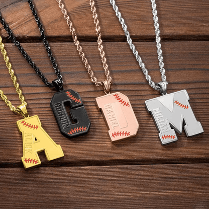 Five personalized baseball-themed pendants on rope chains: gold "A," black "G," rose gold "D," and silver "M," each with red stitching details and engraved names.
