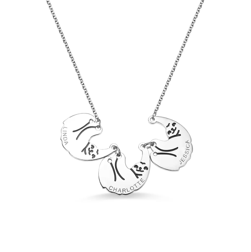 A silver necklace with three interconnected pendants, each featuring an engraved sloth and the names Linda, Charlotte, and Jessica.