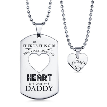 A silver dog tag necklace with "There's this girl who kinda stole my heart, she calls me Daddy" and a heart-shaped pendant reading "Daddy's Girl".