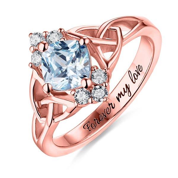 Rose gold engagement ring with a central blue stone, diamond accents, and 'Forever my love' inscription.