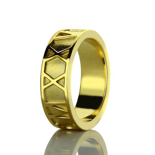 Gold ring with geometric triangular patterns on the outer band and a shiny, smooth inner surface.