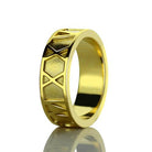 Gold ring with geometric triangular patterns on the outer band and a shiny, smooth inner surface.