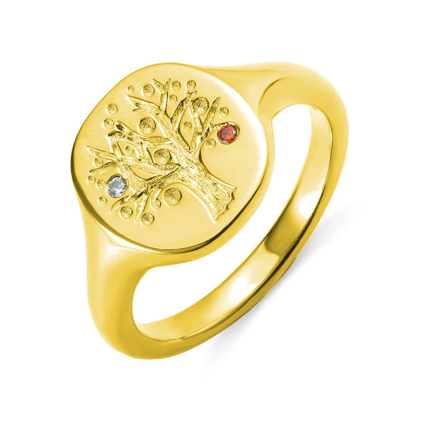 Gold family tree ring with inset birthstones on a white background.