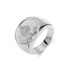 Sterling silver signet ring with detailed crest on a textured background, blending modern and classic styles.