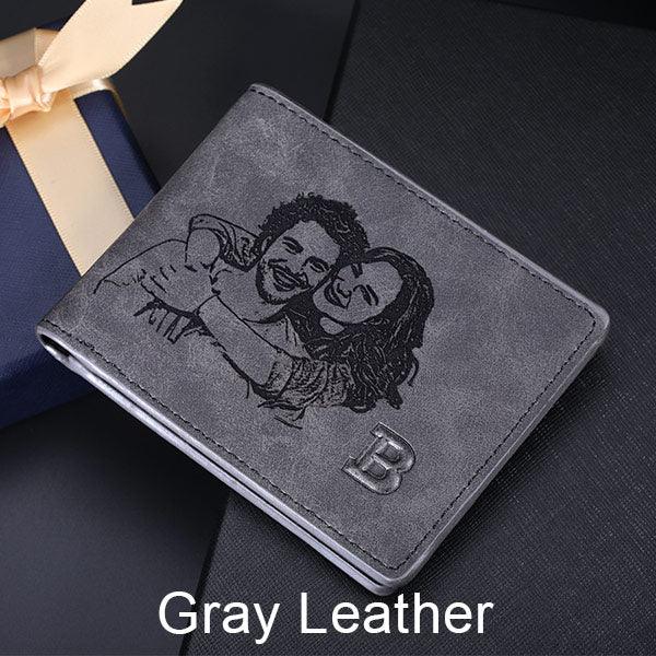 Gray leather wallet with an embossed image of a smiling couple and the initial 'B'.