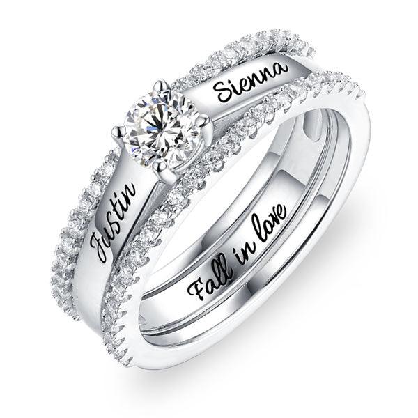 Customizable sterling silver ring set with names 'Justin' and 'Sienna' and 'Fall in Love' engraved, adorned with cubic zirconia
