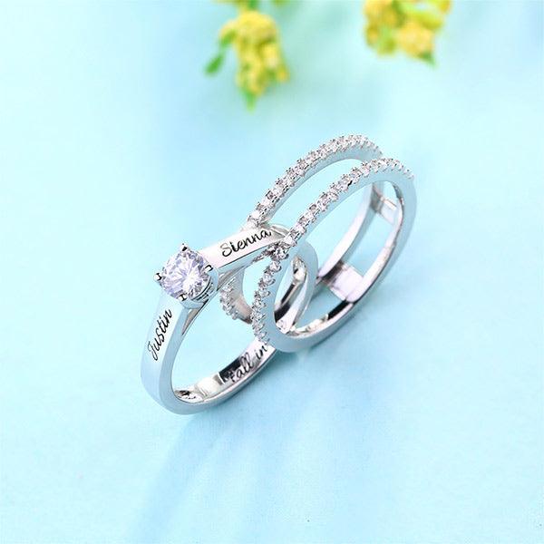 Custom sterling silver double band ring with cubic zirconia, personalized with the names 'Justin' and 'Sienna' on a light blue background."