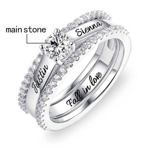Customizable sterling silver ring set with 'Justin' and 'Sienna' engraved, featuring 'Fall in Love' on the inner band and a prominent cubic zirconia