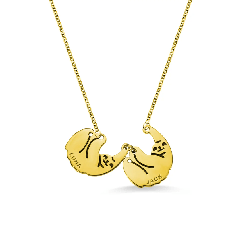 Gold necklace with two interconnected sloth-themed pendants engraved with the names Luna and Jack, displayed on a white background.