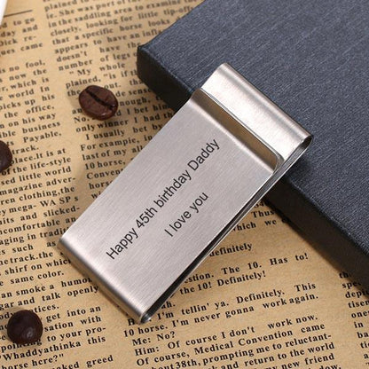 Silver money clip on a book, engraved with 'Happy 45th birthday Daddy I love you