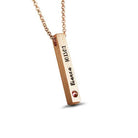 Rose gold necklace with a vertical bar pendant engraved with "Bianca 10.13.02" and a red gemstone on the bottom left corner, displayed on a white background.