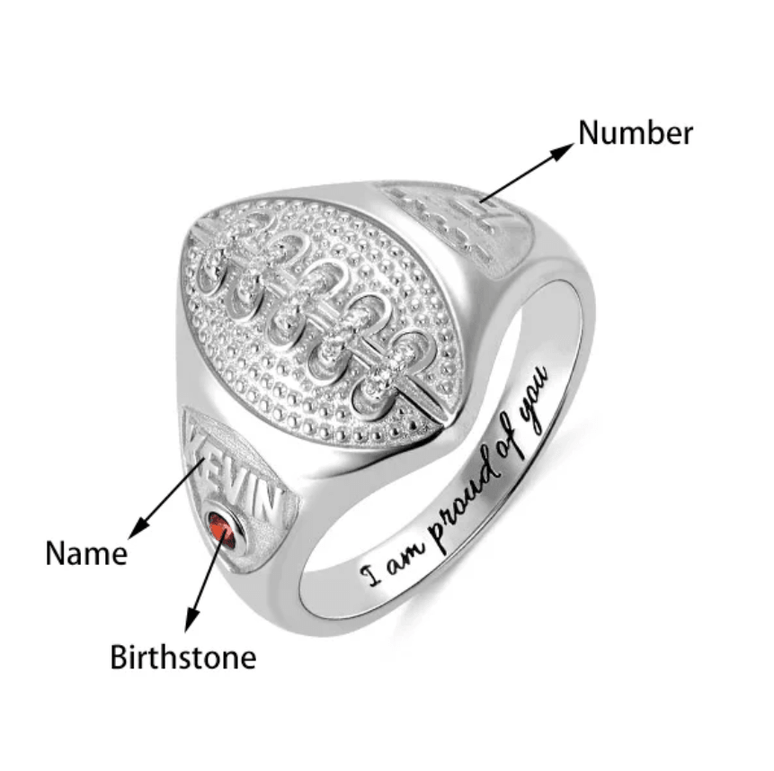 Silver football signet ring with personalized name 'KEVIN', birthstone, and jersey number detail.