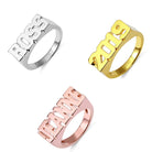 Silver, gold, and rose gold block name rings with 'BOSS', '2019', 'JEANNE' displayed on a white background.