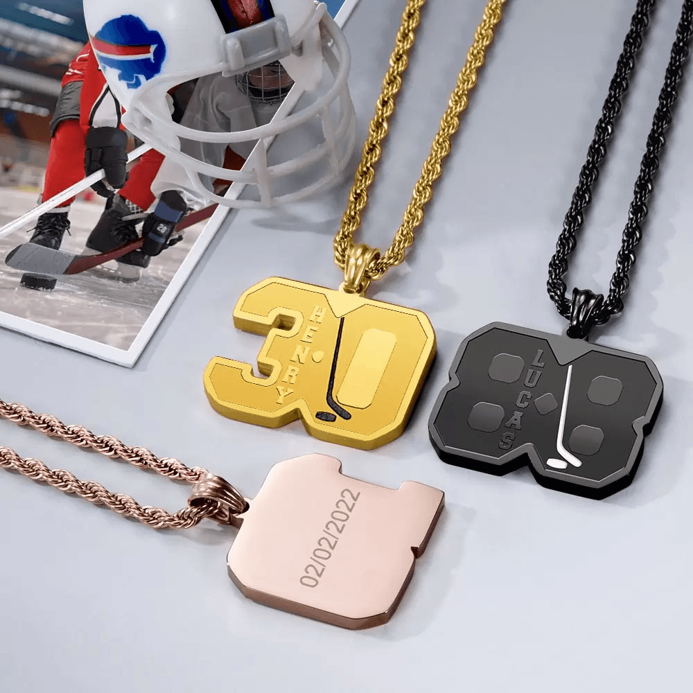 Three custom hockey-themed necklaces: gold with "HENRY" and number 30, black with "LUCAS" and number 88, and rose gold with a date "02022022" on the back, with a hockey gear background.