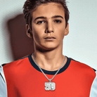 A young boy wearing a red and white shirt, showcasing a silver hockey-themed necklace with the name "JOSON" and number 58.