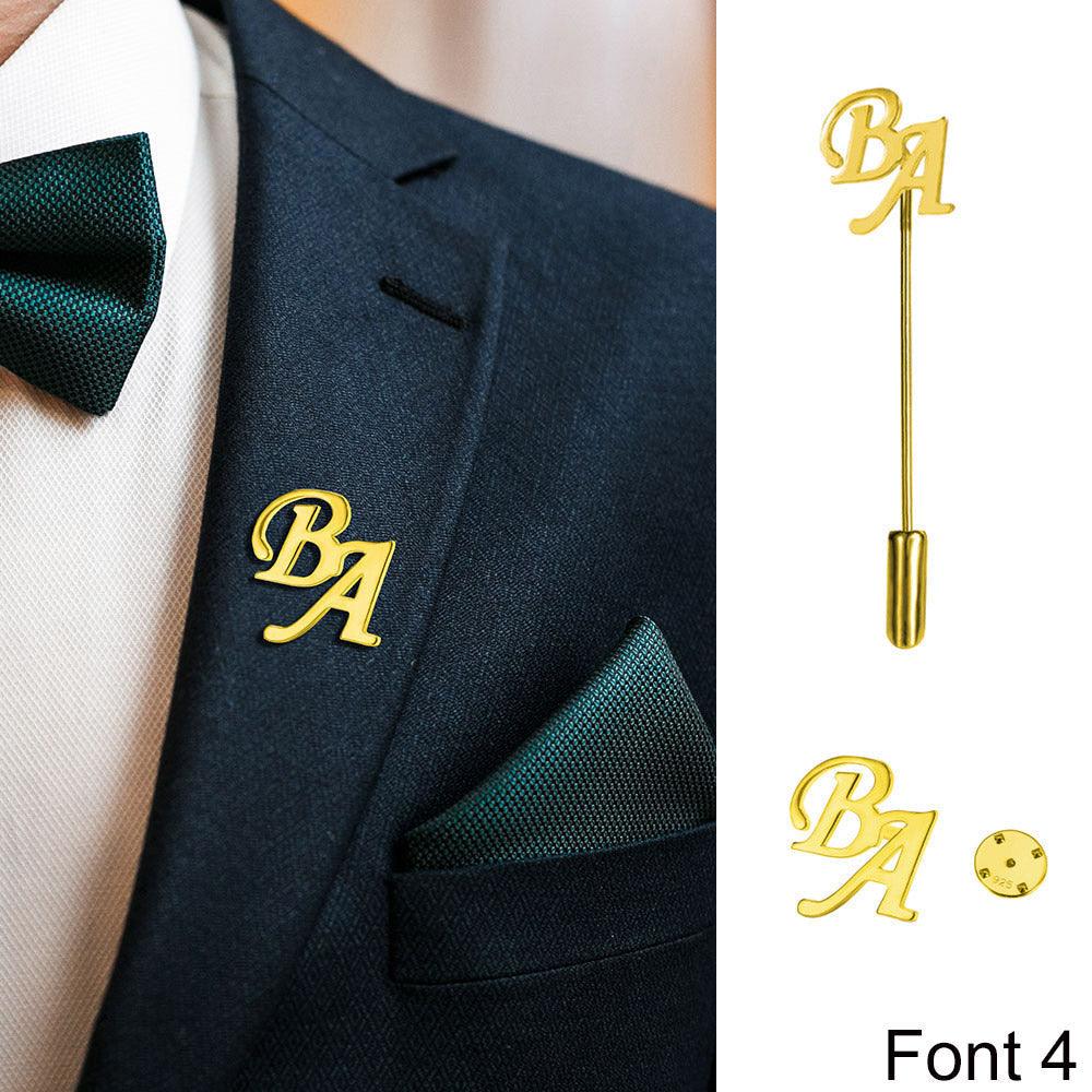 Man in suit with a green tie and pocket square, gold 'BA' lapel pin, and pin design example.