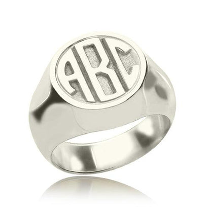 Polished silver signet ring featuring a circular face with 'ABC' block monogram detail.