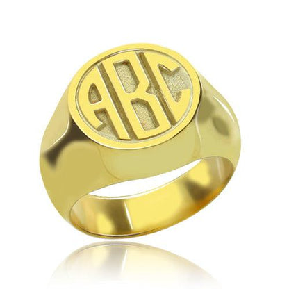 Gleaming gold signet ring with polished 'ABC' block monogram initials on display.