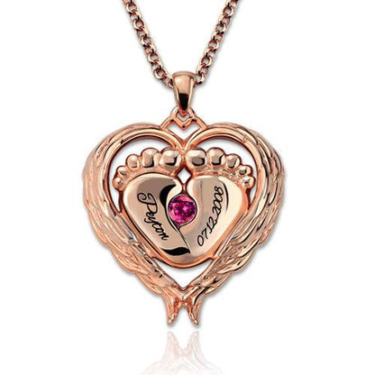 Rose gold heart-shaped necklace pendant featuring baby feet, engraved with the name "Peyton" and the date "07.22.2008," adorned with a pink gemstone.