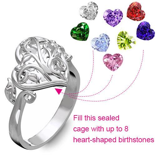 A silver ring with a heart-shaped cage that can be filled with up to eight colorful heart-shaped birthstones.