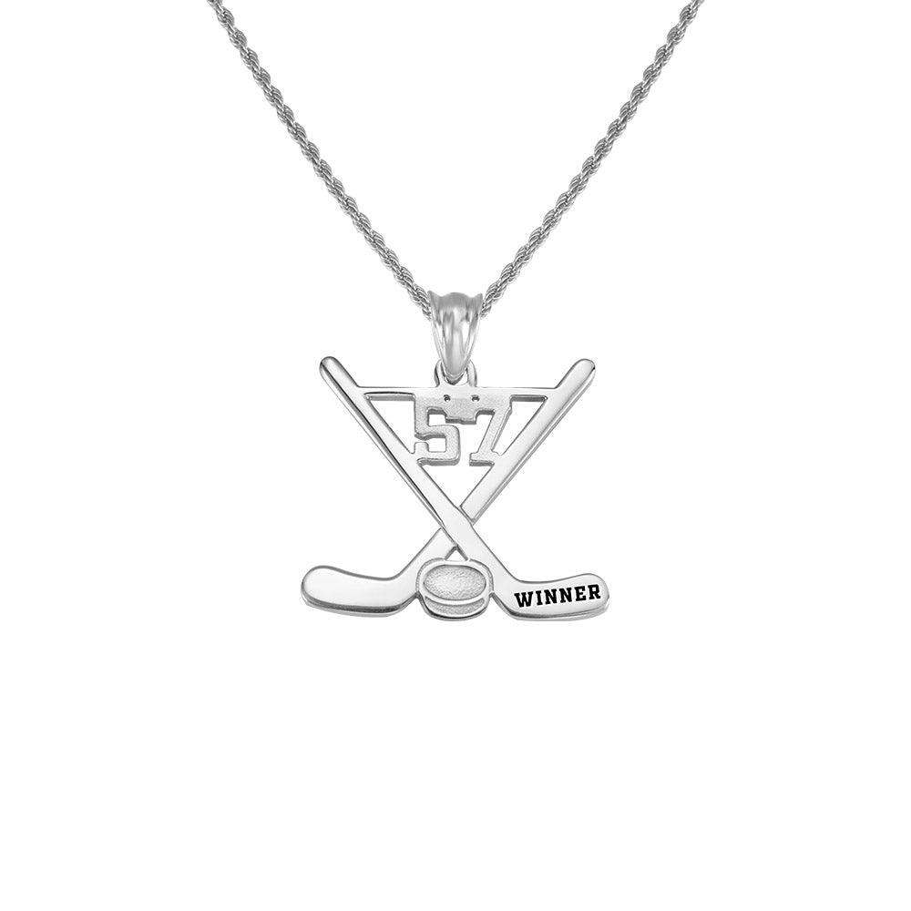 Silver hockey-themed necklace with crossed sticks, a puck labeled "WINNER", and the number 57 engraved on the pendant.