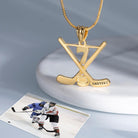 Gold hockey necklace pendant with number 7, next to a hockey action photo, resting on a ceramic stand.