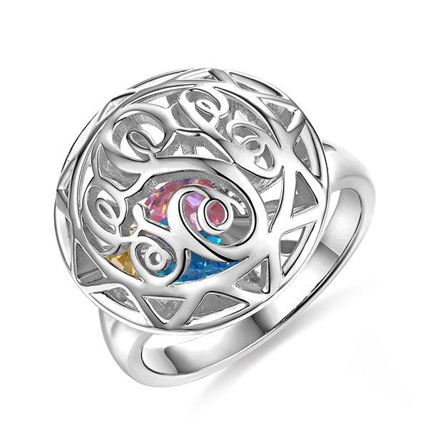 Silver Celtic knot ring with a heart-shaped cage containing colorful birthstones at the center.