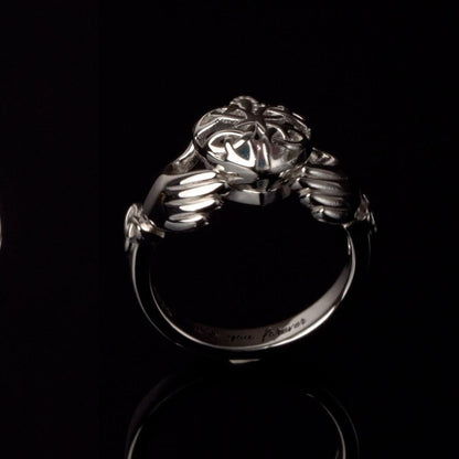 Silver Claddagh ring with heart, hands, and crown design on a black background, engraved with "love you forever