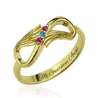 Gold ring with infinity and wing design, featuring pink and blue gemstones and engraved with "My Guardian Angel" inside the band.