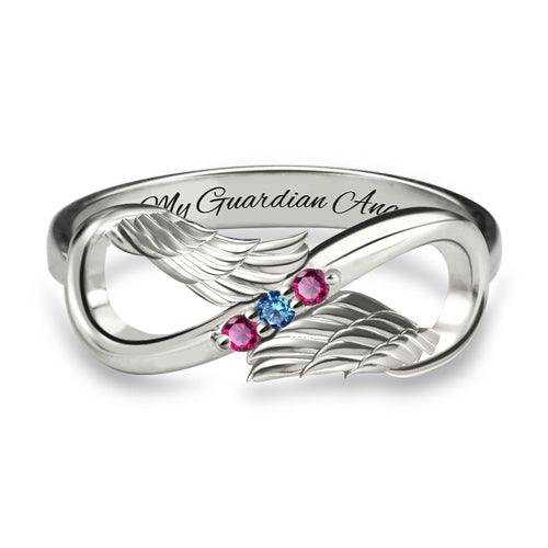 Silver ring with an infinity and wing design, featuring pink and blue gemstones, engraved with "My Guardian Angel" inside the band. Front view.