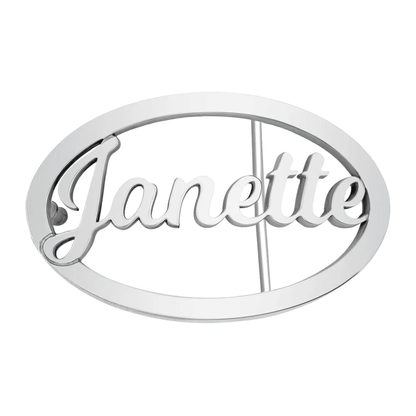 Silver oval belt buckle with 'Janette' in cursive script centered inside, on a white background.