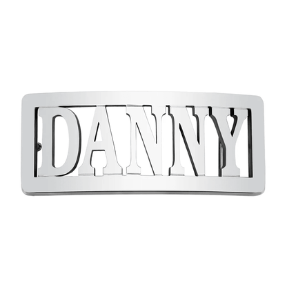 Rectangular silver belt buckle with 'DANNY' in bold uppercase letters, cut through the metal, isolated on a white background.