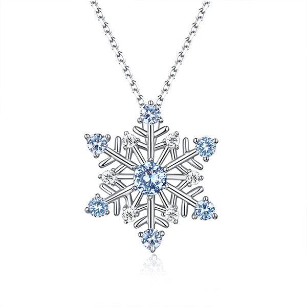 Elegant snowflake pendant necklace in pure silver with sparkling blue stones, perfect for Christmas and winter gifts, displayed on a delicate chain.