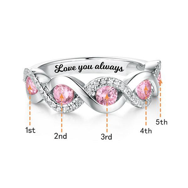A silver ring with pink gemstones in a twisted design, surrounded by small clear stones. The inside is engraved with "Love you always," and each gemstone is labeled from 1st to 5th.