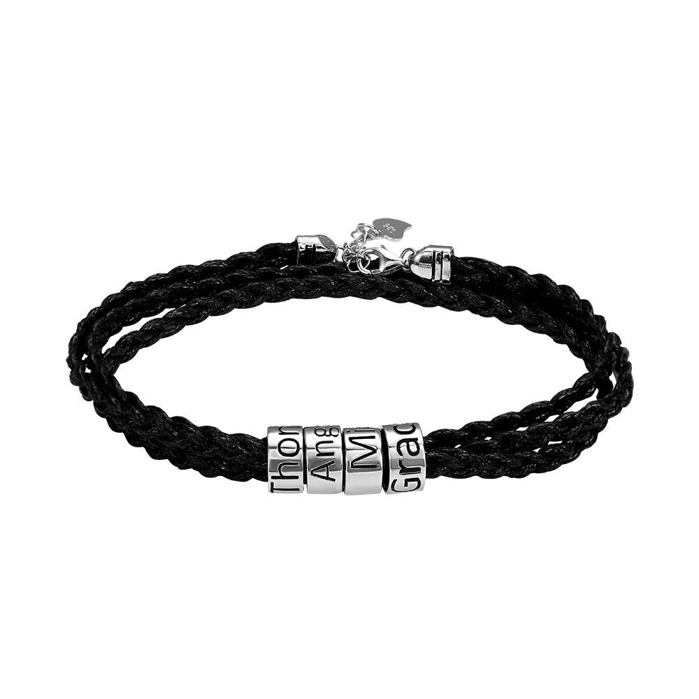 Black braided bracelet with silver beads spelling "I'm a Grad," secured with a lobster claw clasp.