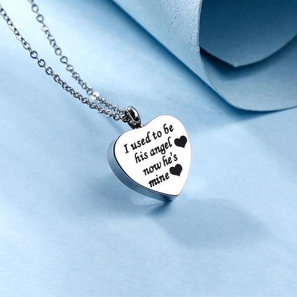 Stainless steel heart-shaped pendant necklace with 'I used to be his angel, now he's mine' inscription on a chain.
