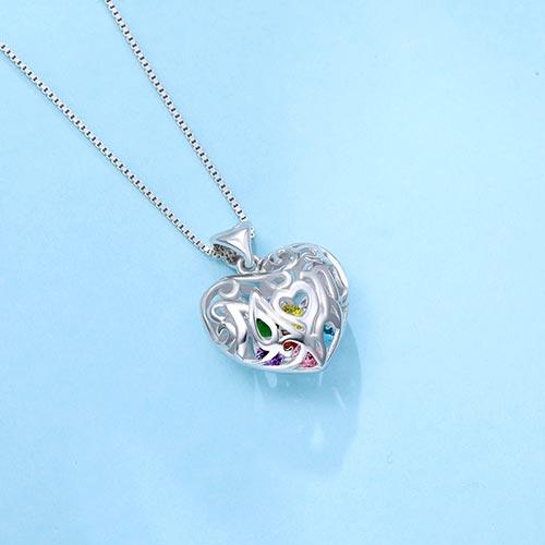 Silver open heart pendant with "Mom" inscribed, featuring colorful birthstones inside, on a box chain necklace against a light blue background.