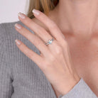 Model wearing a sterling silver personalized birthstone ring with a heart design, showcasing the elegant fit on the hand.