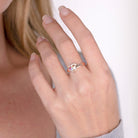 Model wearing a rose gold personalized birthstone ring with heart design and name engraving, highlighting the elegant fit on the hand.