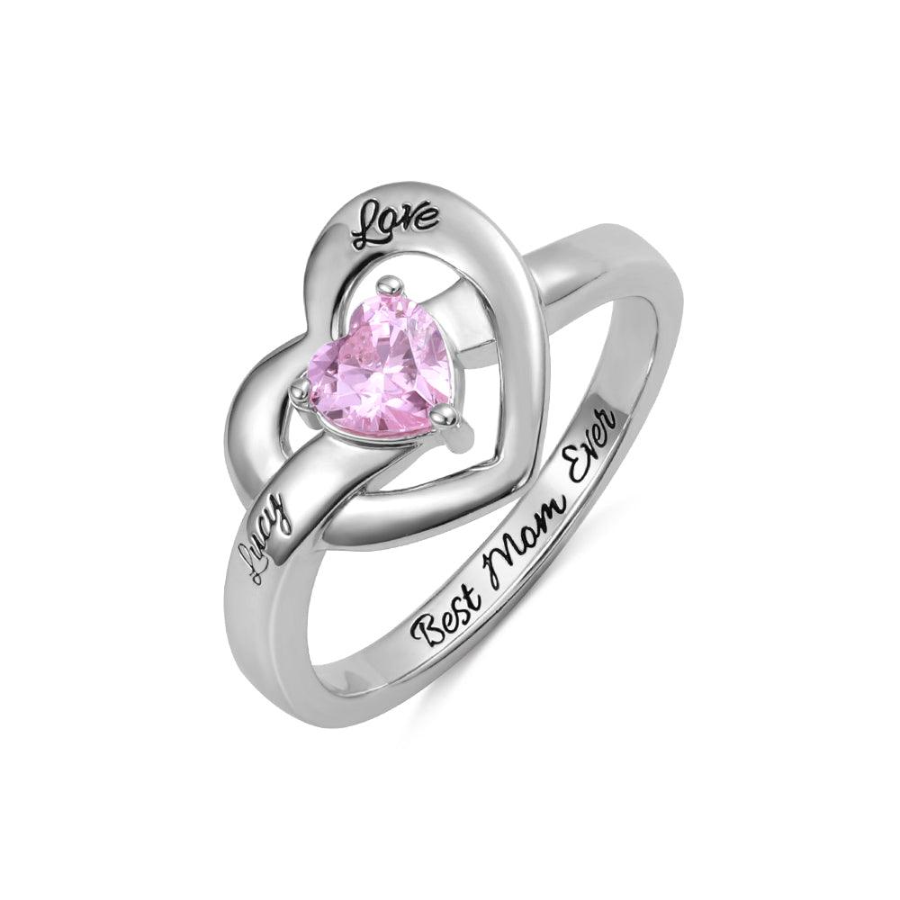 Personalized silver ring with a pink heart-shaped gemstone, engraved with 'Love,' 'Lucy,' and 'Best Mom Ever,' symbolizing affection and appreciation.