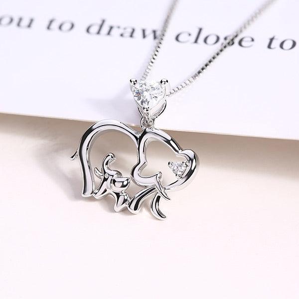 Sterling silver necklace featuring a baby and mother elephant design with a heart-shaped birthstone pendant, symbolizing maternal love and protection.