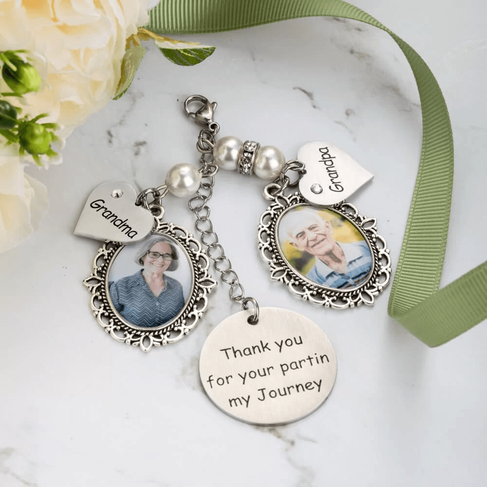 Bouquet charms with photos and 'Thank you' note for grandparents on marble.