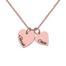 A rose gold necklace with two heart-shaped pendants, one engraved with "Sarah" and the other with "Chloe," on a white background.