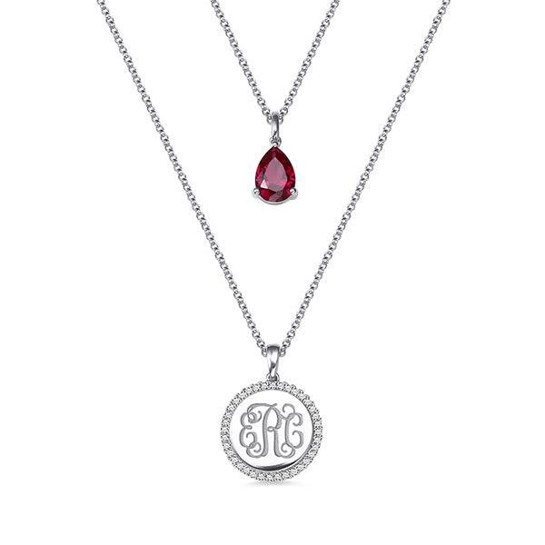 Double-layered necklace in sterling silver with a teardrop birthstone pendant and CZ monogram pendant, perfect for personalized gifts and special occasions.