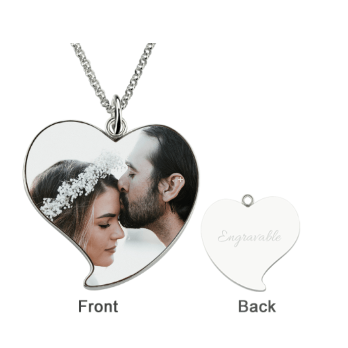 Sterling silver heart-shaped photo pendant with a rollo chain, showing a man kissing a woman's forehead on the front and an engravable blank back.